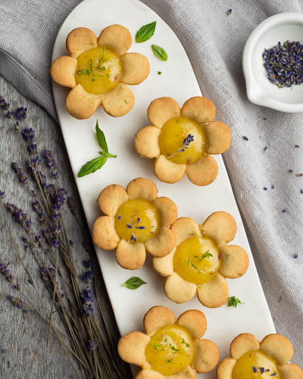 Tartelettes en forme de fleurs sur un plateau marbré