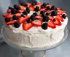 Gâteau des anges avec crème fouettée et coulis de fruits rouges
